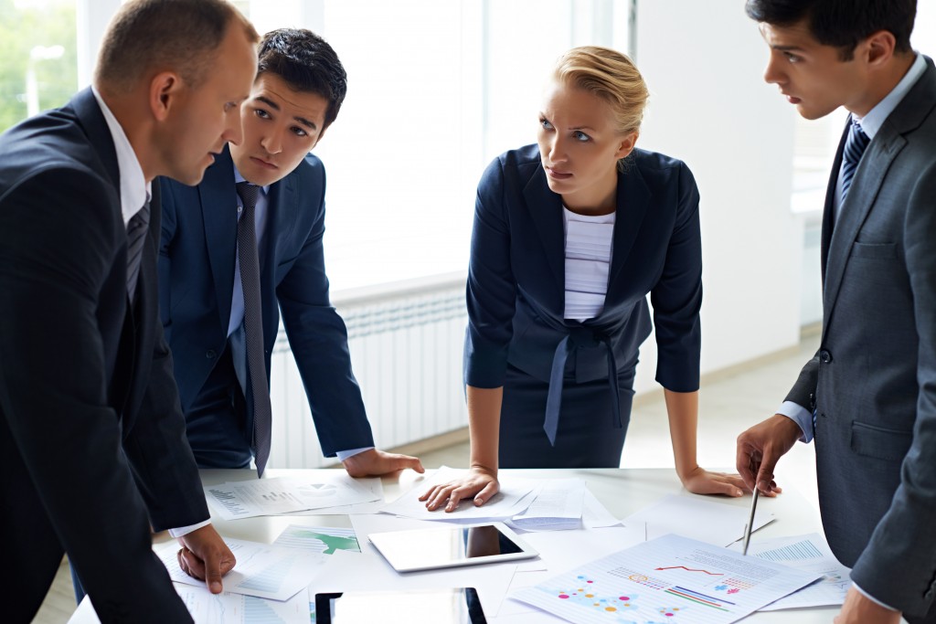 Four professionals in a business meeting