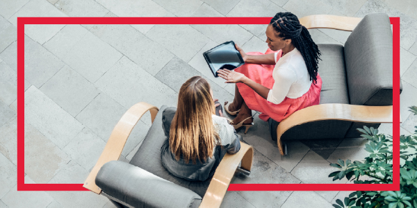 Women consulting about business looking at a tablet