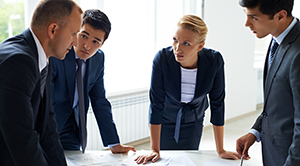 Four professionals in a business meeting