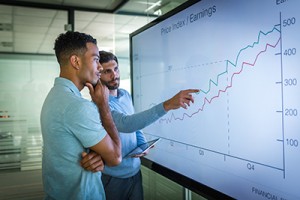 Two professionals analyzing and interpreting data