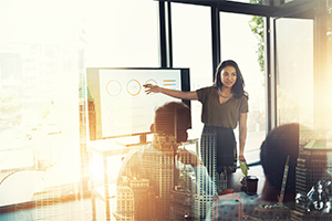 Woman giving presentation at group office meeting